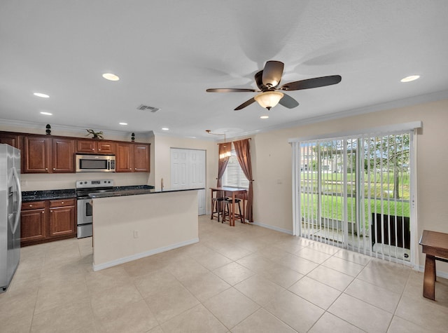 2185 SW Rockport Rd, Port Saint Lucie, FL 34953 - kitchen with stainless steel appliances, dark countertops, visible vents, a ceiling fan, and ornamental molding