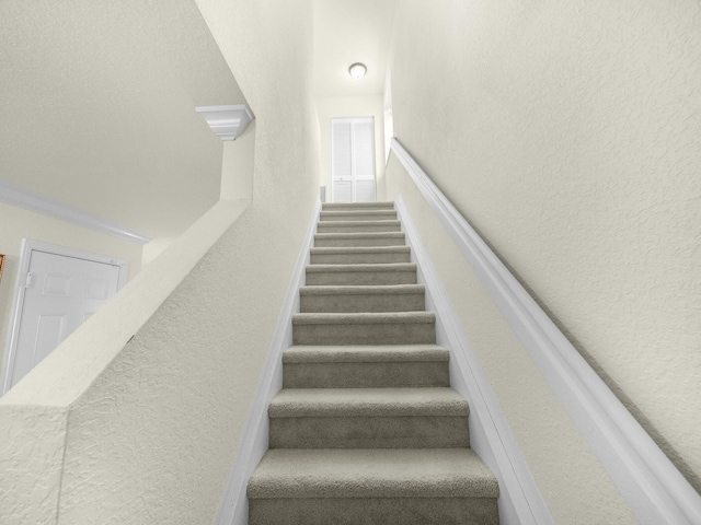 2185 SW Rockport Rd, Port Saint Lucie, FL 34953 - staircase featuring a textured wall