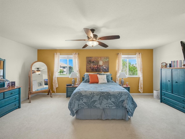 bedroom featuring carpet flooring, multiple windows, and a ceiling fan