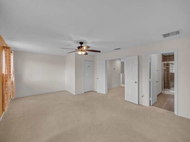 2185 SW Rockport Rd, Port Saint Lucie, FL 34953 - unfurnished bedroom featuring light colored carpet, ceiling fan, baseboards, and visible vents