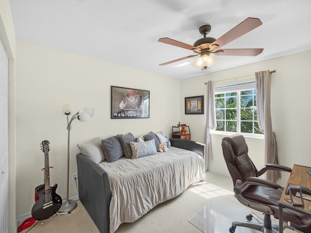 carpeted bedroom featuring a ceiling fan and baseboards