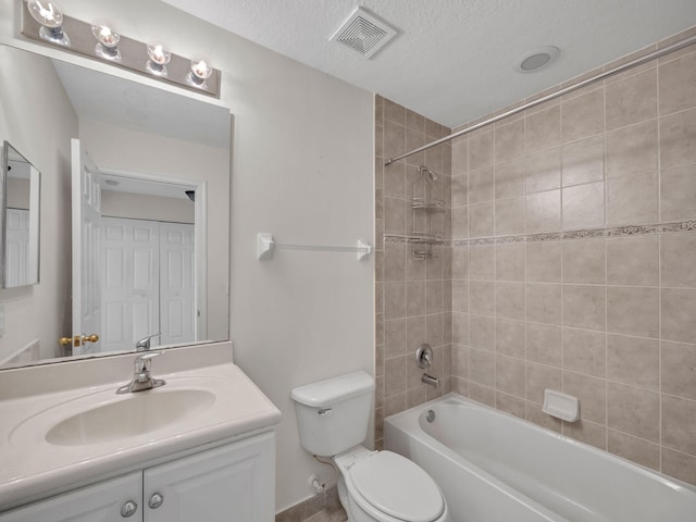 2185 SW Rockport Rd, Port Saint Lucie, FL 34953 - bathroom with a textured ceiling, vanity, bathtub / shower combination, toilet, and visible vents