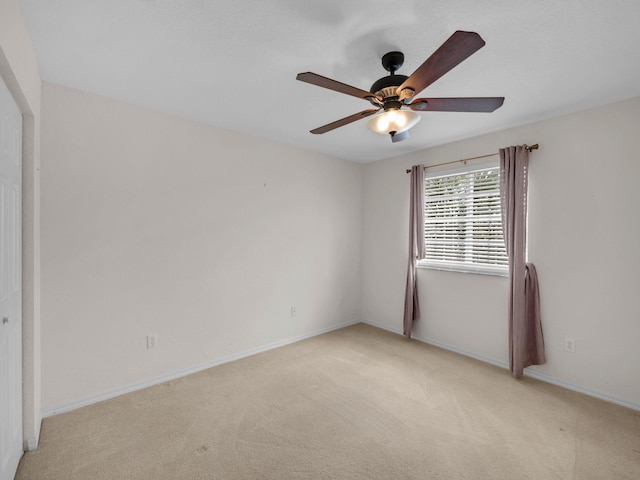 2185 SW Rockport Rd, Port Saint Lucie, FL 34953 - unfurnished room with light carpet, baseboards, and ceiling fan