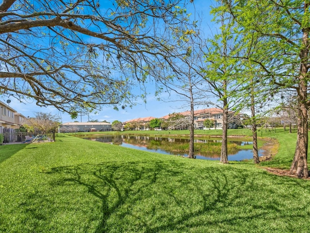 2185 SW Rockport Rd, Port Saint Lucie, FL 34953 - view of yard with a residential view, a water view, and fence