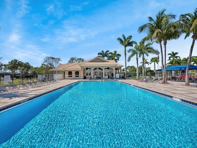 community pool featuring a patio area and fence