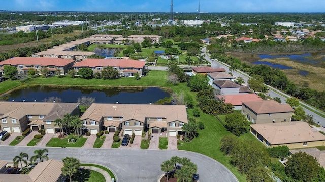 drone / aerial view featuring a residential view and a water view