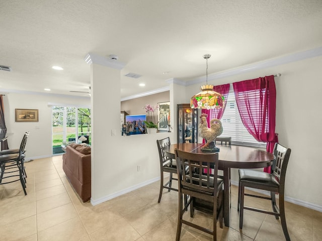 dining room with light tile patterned flooring, visible vents, baseboards, and ornamental molding