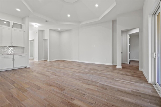basement with baseboards, light wood-style floors, and recessed lighting