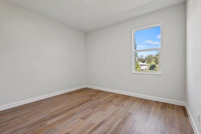 unfurnished room featuring light wood-style flooring and baseboards