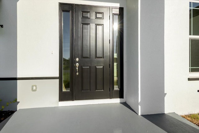 property entrance featuring stucco siding