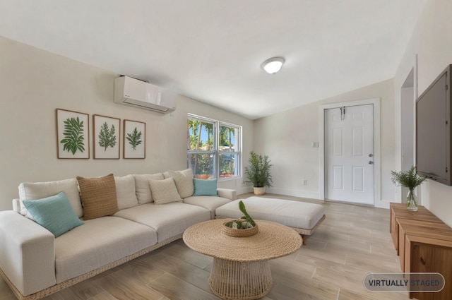 living room featuring a wall unit AC, baseboards, light wood-type flooring, and lofted ceiling