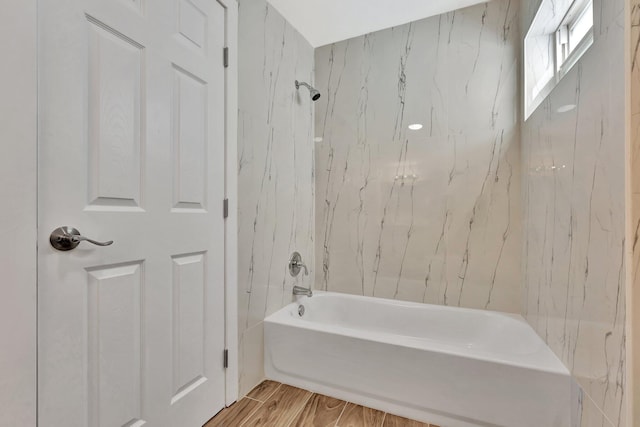 bathroom featuring tub / shower combination and wood finished floors