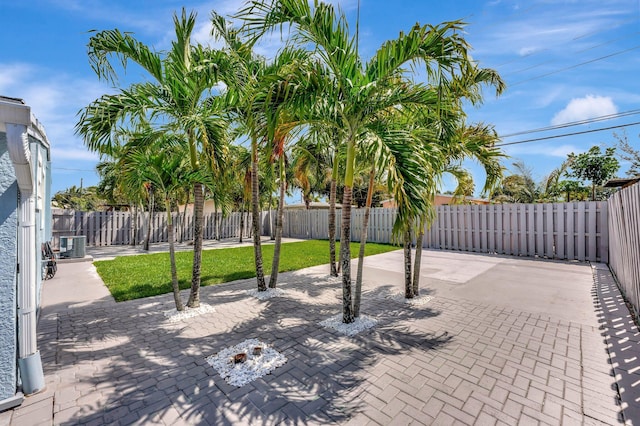 view of patio featuring central AC unit and a fenced backyard