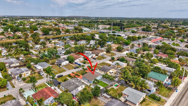 birds eye view of property featuring a water view and a residential view