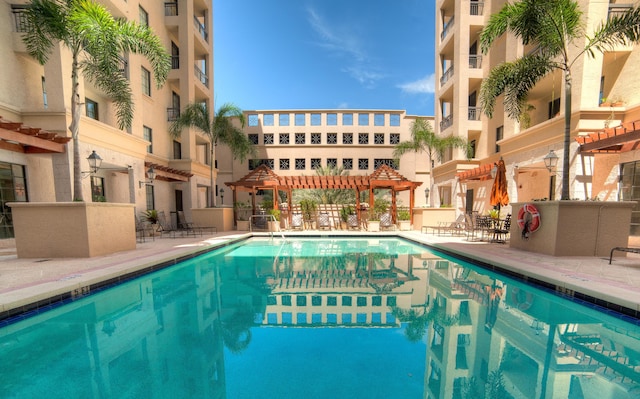 pool featuring a patio and a pergola