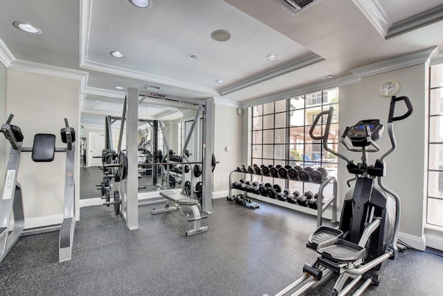 exercise room with baseboards, visible vents, a raised ceiling, ornamental molding, and recessed lighting