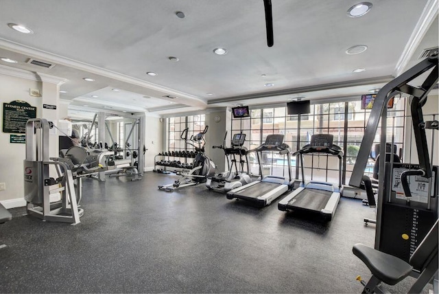 workout area featuring baseboards, visible vents, and ornamental molding