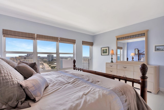 bedroom with a view of city and crown molding