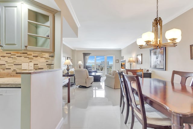 dining space with light tile patterned floors, a notable chandelier, and crown molding