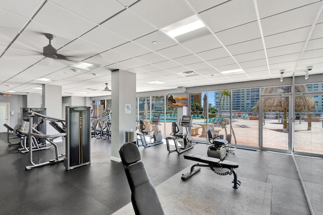 workout area with visible vents, a drop ceiling, and ceiling fan