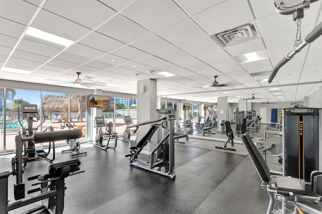 gym featuring visible vents, a drop ceiling, and ceiling fan