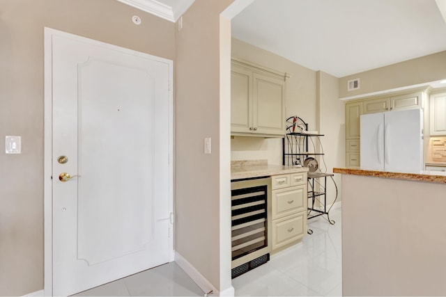 interior space featuring visible vents, baseboards, beverage cooler, and light tile patterned flooring