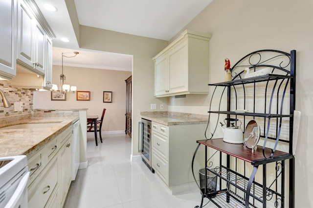 kitchen featuring baseboards, white dishwasher, wine cooler, range, and backsplash