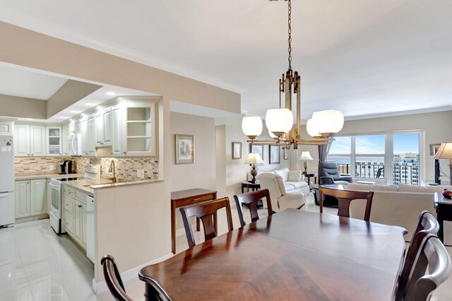 dining room featuring an inviting chandelier and ornamental molding