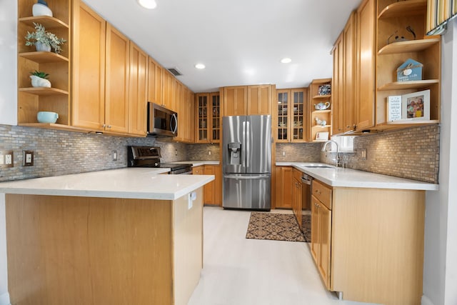 kitchen with visible vents, open shelves, appliances with stainless steel finishes, a peninsula, and a sink