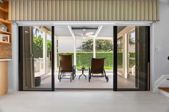 doorway with a sunroom and ceiling fan