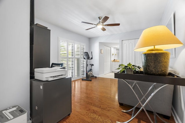 office featuring baseboards, a ceiling fan, and wood finished floors