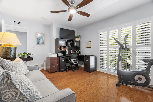 office area featuring ceiling fan, visible vents, and wood finished floors