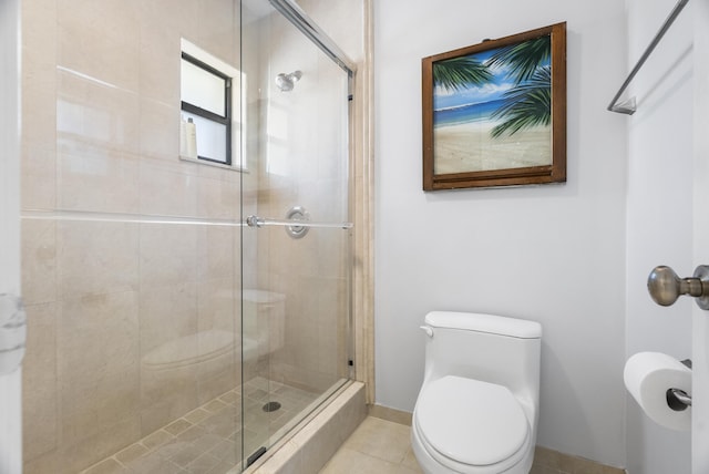 full bathroom featuring tile patterned floors, baseboards, toilet, and a stall shower