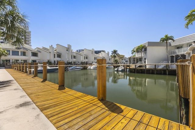 dock area featuring a residential view and a water view