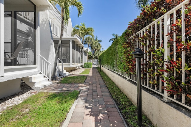 view of yard with a sunroom and fence