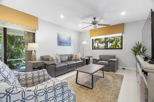 living area with recessed lighting, baseboards, and ceiling fan