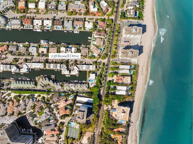 birds eye view of property with a beach view and a water view