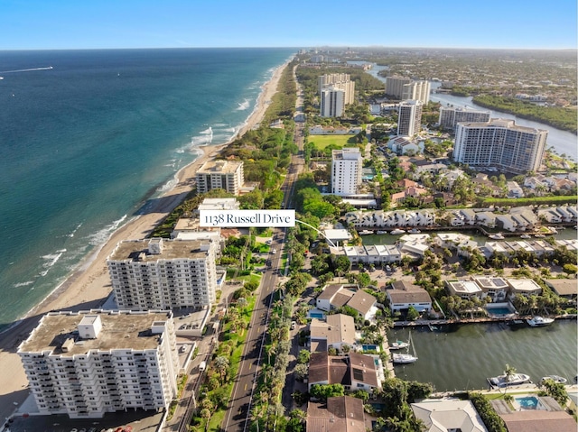 drone / aerial view featuring a city view, a beach view, and a water view