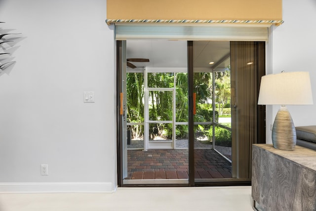 doorway to outside with ceiling fan