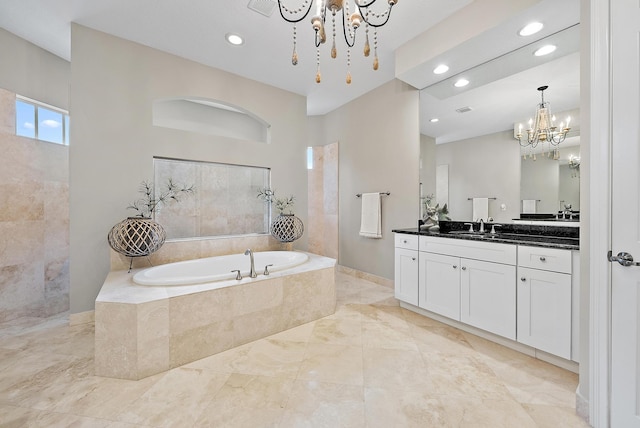 bathroom featuring baseboards, recessed lighting, a bath, a notable chandelier, and vanity