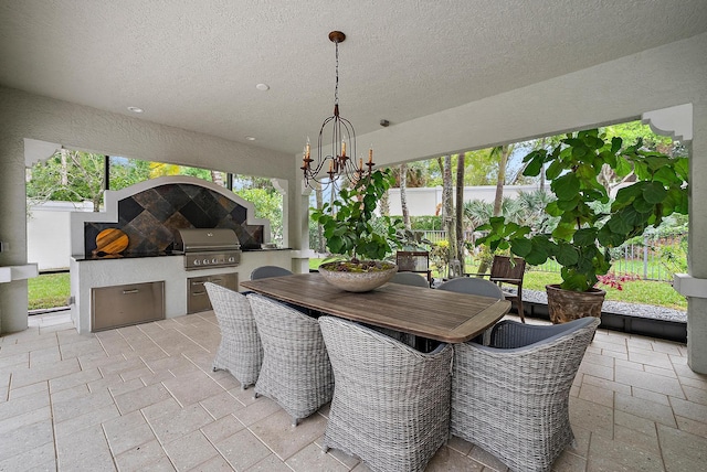 view of patio featuring outdoor dining space, exterior kitchen, area for grilling, and fence