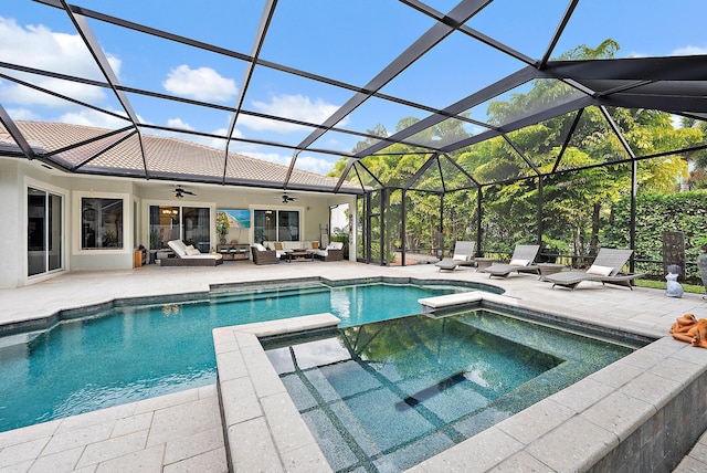 view of swimming pool with a ceiling fan, a pool with connected hot tub, an outdoor living space, glass enclosure, and a patio area