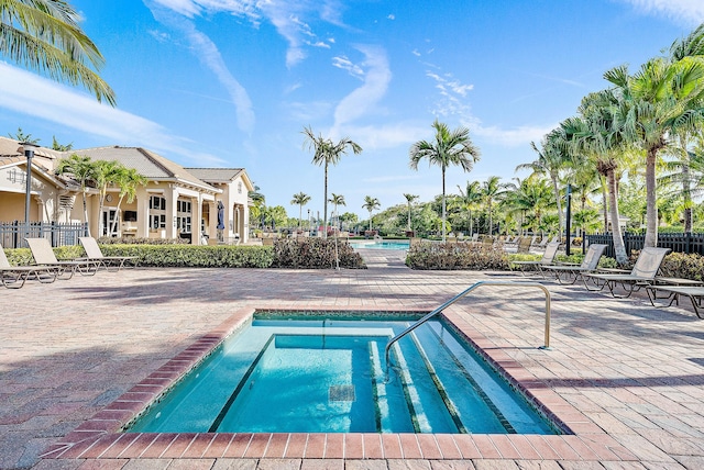 community pool featuring a patio area and fence