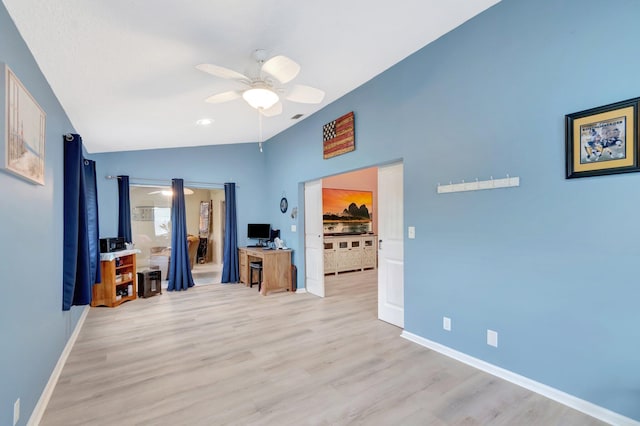 living area featuring lofted ceiling, a ceiling fan, light wood-style floors, and baseboards