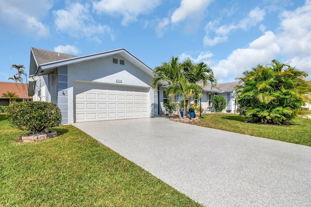 ranch-style home with a garage, stucco siding, concrete driveway, and a front lawn