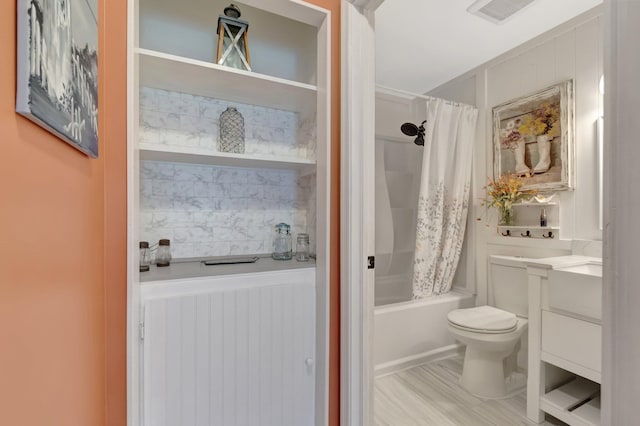 full bath with visible vents, toilet, vanity, and shower / bath combo