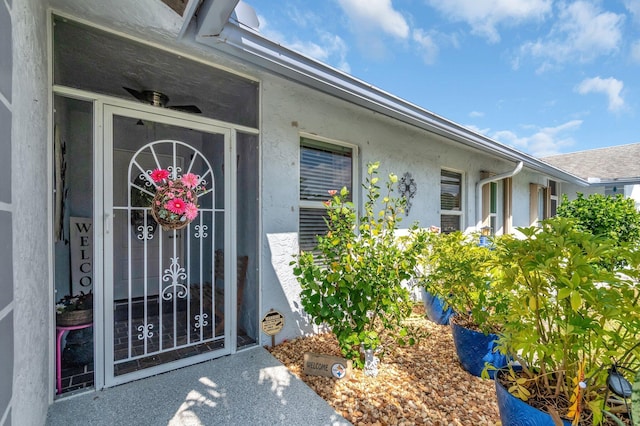 property entrance featuring stucco siding