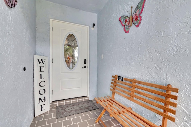 entrance to property featuring stucco siding