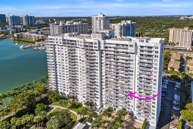 drone / aerial view featuring a water view and a view of city