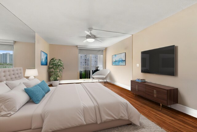 bedroom with multiple windows, baseboards, and wood finished floors